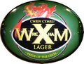 Oval rugby ball, black for coal, green for pasture and Welsh gold topped by a fire breathing dragon. The Wrexham logo