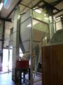 The grain chute above the AR2000 two roller mill and the conveyor back up to the grist case