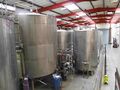 The view from the brewers office with the wort heat exchangers in front of the FVs with CTs behind hiding the racking plant. The ale stores is over to the right