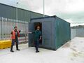 An ISO container doubles as a micro 'airlock'. Operators change clothes and footwear within