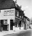 A common example of their pub exteriors. Note the Reid's Stout sign as well as their own.