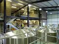 A view across the fermenter tops to the mash tun and hop back below the copper and grist case. The brewplant is by Musk and the vessels from Velo